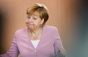 German chancellor Angela Merkel arrives for her first cabinet meeting after her summer holidays in the Chancellery in Berlin, Germany, Wednesday, Aug. 12, 2015. (AP Photo/Gero Breloer)