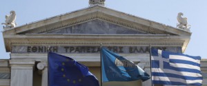 Flags from right, Greek, National Bank of Greece and the European Union flags wave outside the headquarters of the National Bank of Greece in Athens, on Friday, Sept. 23, 2011. Moody's ratings agency downgraded eight Greek banks by two notches Friday due to their exposure to Greek government bonds and the deteriorating economic situation in the country, whose government has struggled to meet the terms of an international bailout. (AP Photo/Petros Giannakouris)