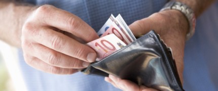 Man counting banknotes in wallet